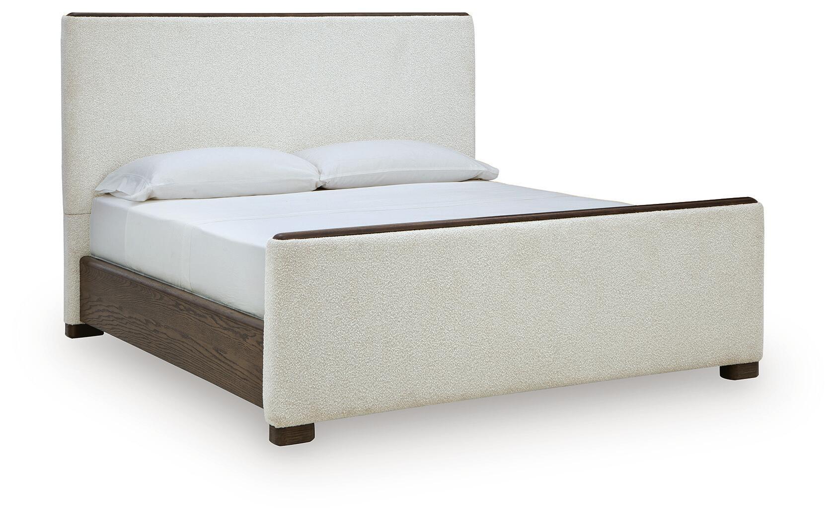 Radkin – Queen Upholstered Panel Bed – Burnished Brown