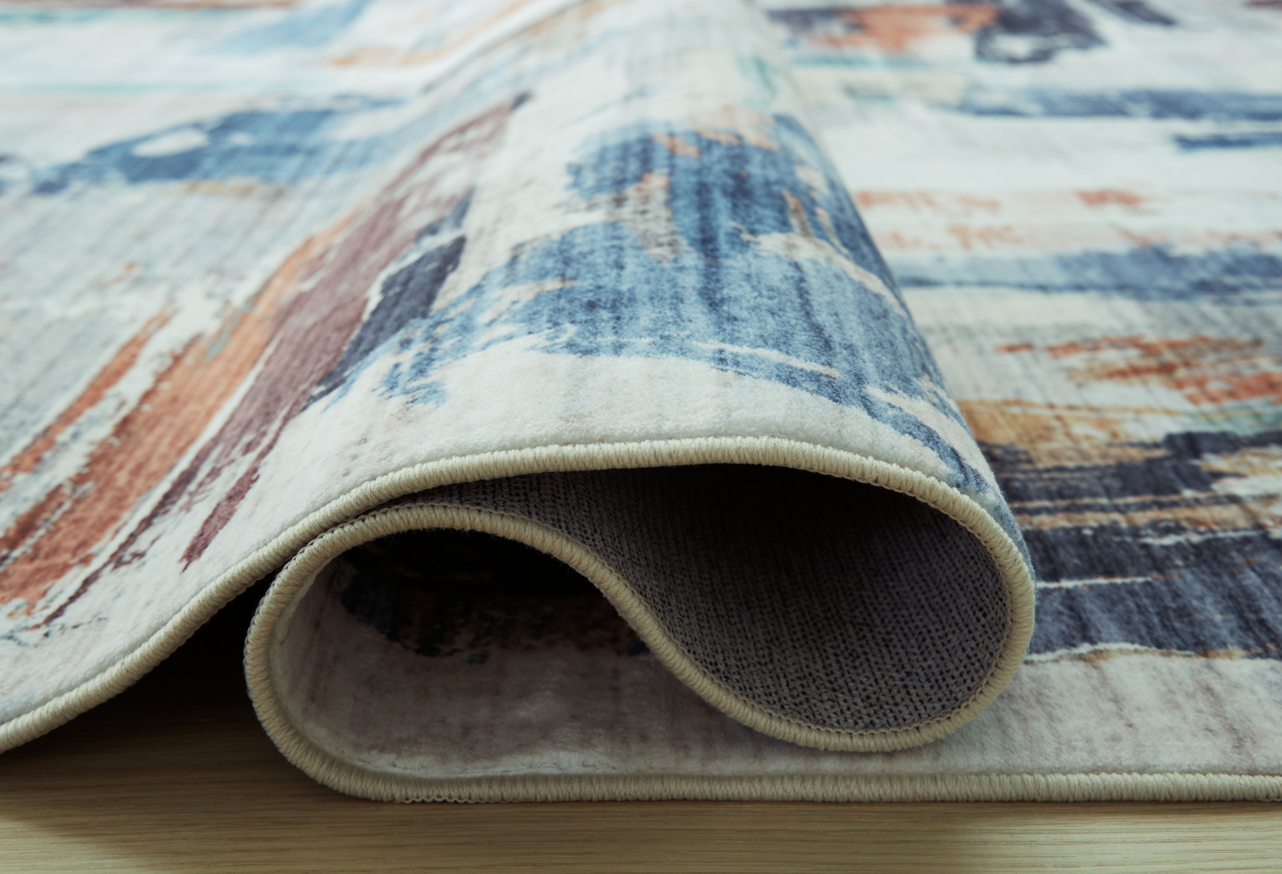 Ashley Furniture Vinlett - 5' x 7' Washable Rug - Cream / Blue / Brown - Image 4